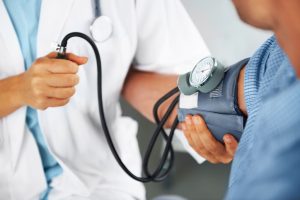 A doctor measuring a patient's blood pressure.